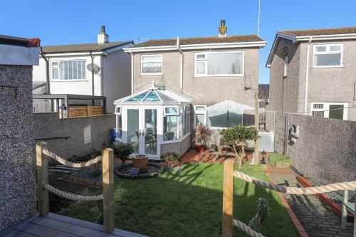 a backyard of a house with a gazebo at Glasfryn in Holyhead