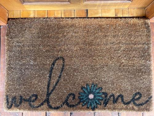 a welcome mat with the word welcome written on it at Full Belizean Cabin in Spanish Lookout