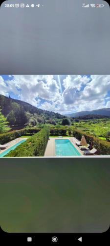 a television screen with a picture of a swimming pool at Il Viaggio Verde in Vasiliki