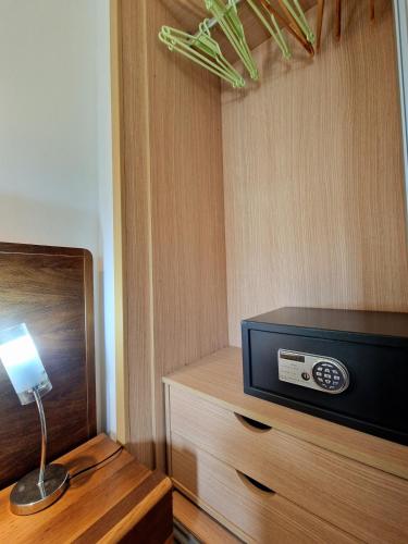 a room with a tv and a table with a lamp at Stay, laugh, repeat! in Prainha
