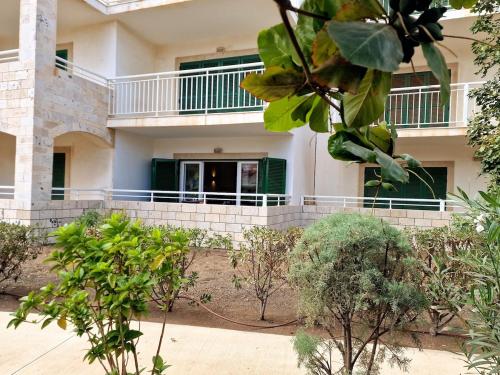 a building with a balcony and trees in front of it at Stay, laugh, repeat! in Prainha