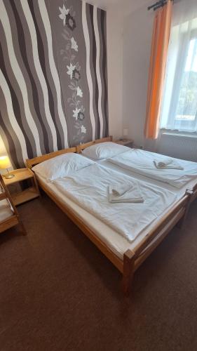a large bed in a bedroom with at Pension Valja in Janske Lazne