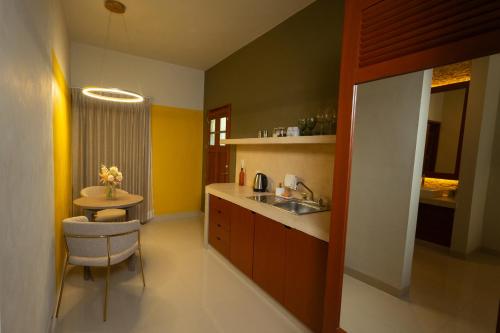 a small kitchen with a sink and a table at Hotel Poquito a Poquito in Valladolid