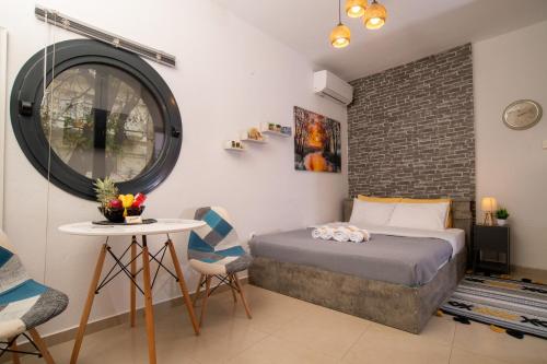 a bedroom with a bed and a table and chairs at Central & Riverfront Room 1 in Edessa