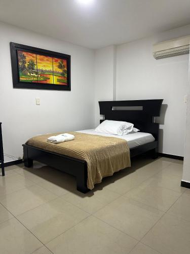 a bedroom with a bed in a room at Hotel Palmeras De Mariana in Bucaramanga