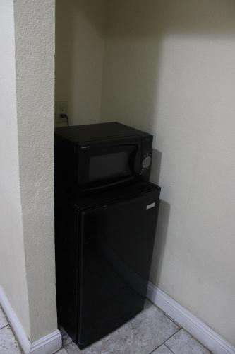 a black television sitting on top of a refrigerator at El Rancho Motel in Yuma