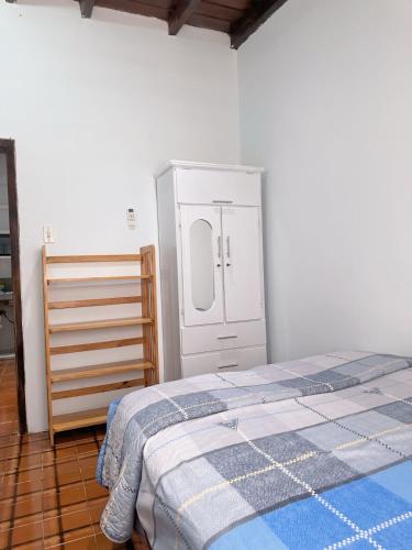 a bedroom with a bed and a cabinet in it at Punta Blanca Beach House Amazing for Families in Punta Blanca