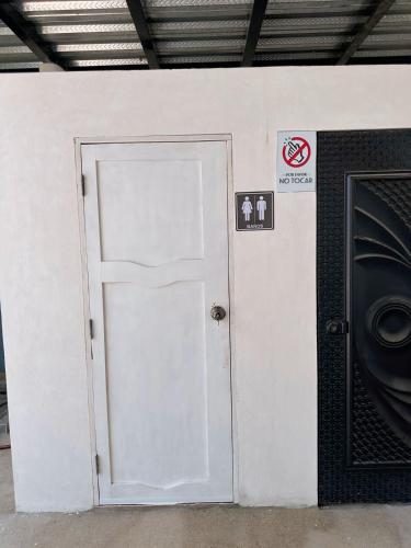a white door in a wall with a speaker at Punta Blanca Beach House Amazing for Families in Punta Blanca