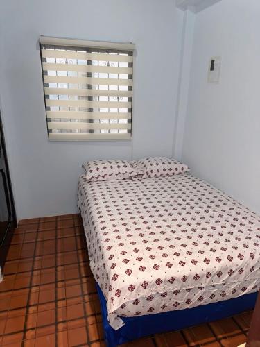 a bed in a room with a window at Punta Blanca Beach House Amazing for Families in Punta Blanca