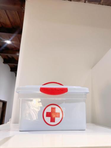 a white container with a red cross on it at Punta Blanca Beach House Amazing for Families in Punta Blanca
