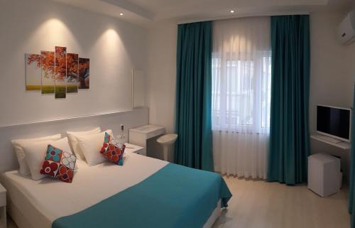 een slaapkamer met een bed en een raam met groene gordijnen bij Payidar HOTEL in Istanbul