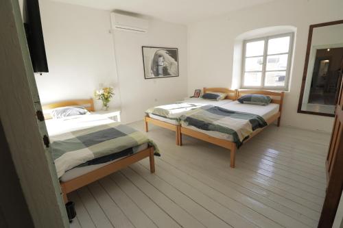 una camera da letto con due letti e una finestra di Light filled spacious penthouse in Šibenik city centre a Šibenik