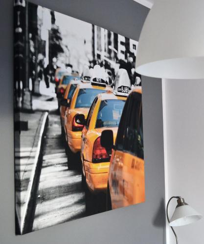 a bunch of taxis are lined up on a street at Hotel Graffit in Świebodzin