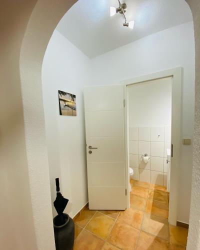 a bathroom with a toilet and a white door at Ferienhaus Malente in Malente