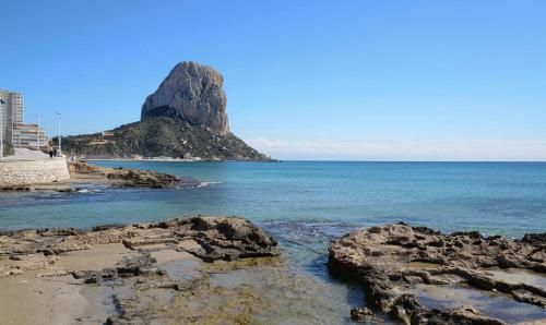 a view of an island in the ocean with rocks at Residencial Terra de Mar Calpe, Grupo Terra de Mar, alojamientos con encanto in Calpe