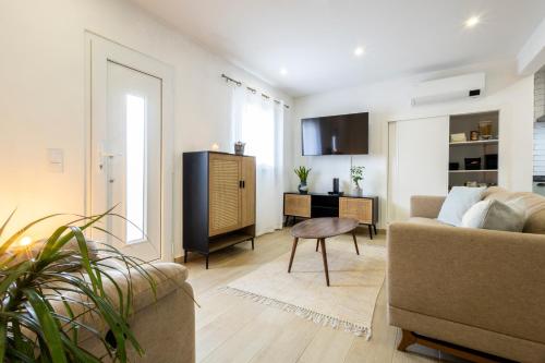 a living room with a couch and a table at CASA Castelejo in Vila do Bispo