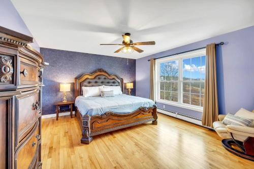 a bedroom with a bed and a ceiling fan at Serene 7BR Haven by the Lake home in Sullivan