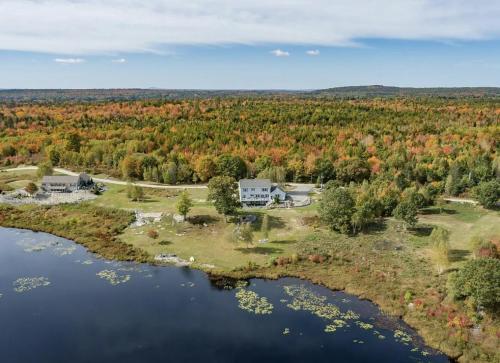 an aerial view of a house on an island in a lake at Serene 7BR Haven by the Lake home in Sullivan