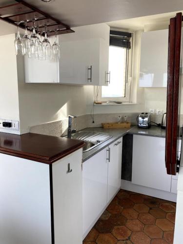 a kitchen with white cabinets and a sink at Star rain in Paris