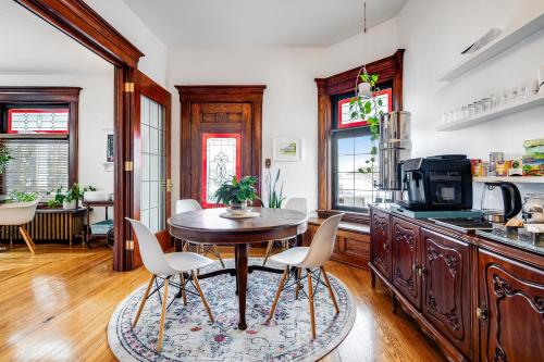 a kitchen with a table and chairs in a room at The Miracle Room at Dream BNB Estate Inn in Leamington