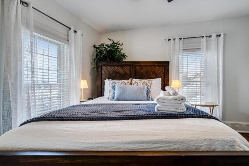 a bedroom with a large bed with towels on it at The Miracle Room at Dream BNB Estate Inn in Leamington