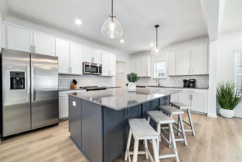 a kitchen with white cabinets and a stainless steel refrigerator at Endless Summer in Orange Beach