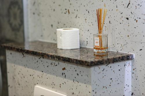 a counter with a roll of toilet paper and a container of matches at Hotel Privé in Peje