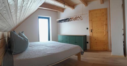 a bedroom with a bed and a wooden door at Bobrštajn in Žacléř
