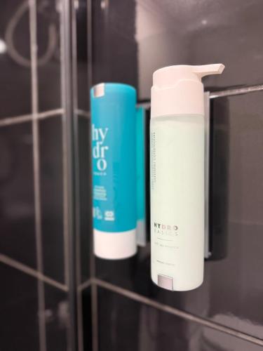 two bottles of my off lotion sitting on a shelf at luxury studio archit 14 street in Patra