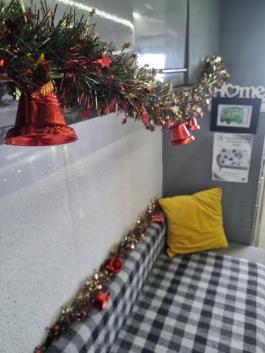 a room with a bed with christmas decorations on it at Military Shepherd Hut in Haxey