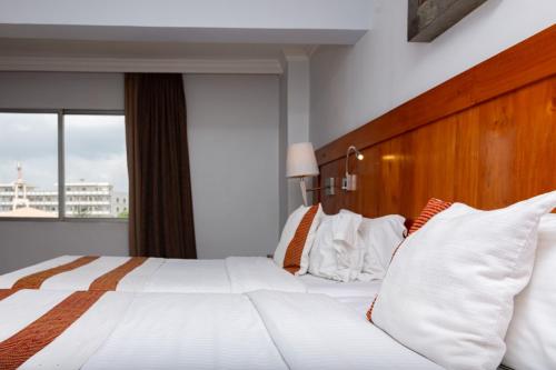 Voodi või voodid majutusasutuse Hotel Du Lac toas