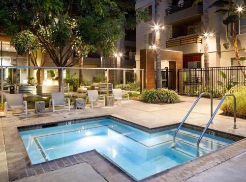 a swimming pool in front of a building at 2BD 2BA Santa Monica Apartment with Relaxing Pool View in Los Angeles
