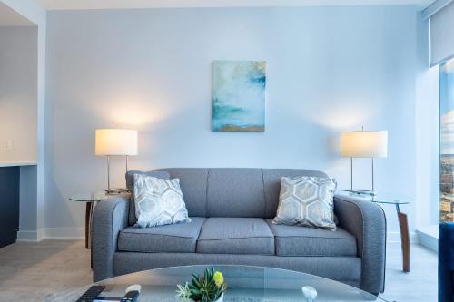 a living room with a couch and a table at Chic Apt with Indoor Pool & Gym-333-2509 in New Rochelle