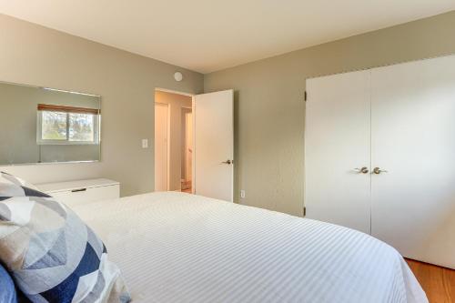 a bedroom with a white bed and a closet at Outdoor Adventurers Oasis in White Salmon in White Salmon