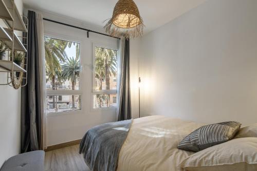 a bedroom with a bed and a large window at Laguna Home in Ayamonte
