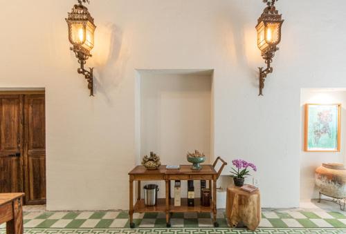 a room with a table and lights on the wall at Orchid House San Miguel de Allende in San Miguel de Allende