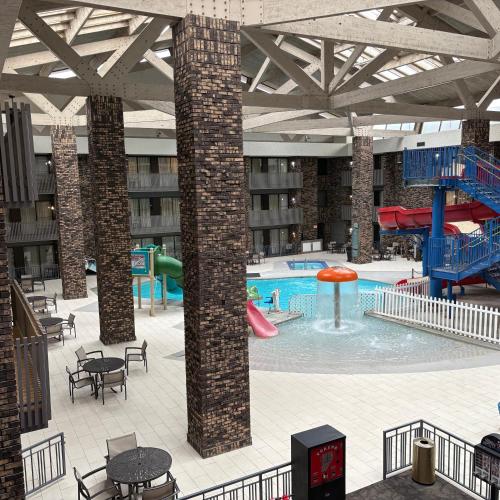 a large swimming pool with a slide in a building at Bismarck Hotel and Conference Center in Bismarck