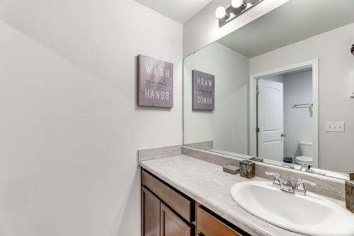 a bathroom with a sink and a mirror at 17 Mi to Dtwn Nashville Family-Friendly Gem in Antioch