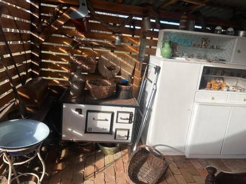 a kitchen with a stove and a refrigerator at Kunyhó in Egeraracsa