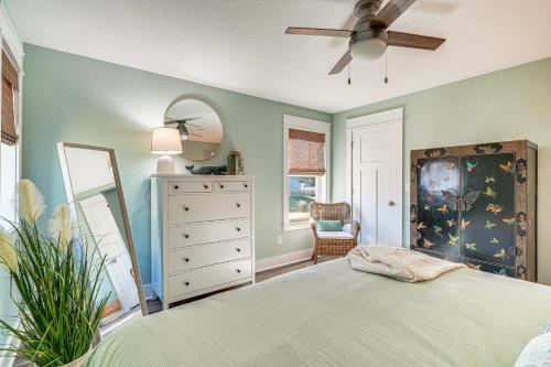 a bedroom with a bed and a dresser and a mirror at Walk to Beach Apt with Private Hot Tub! in Kill Devil Hills