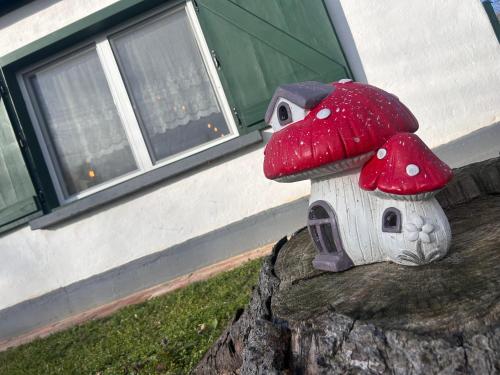 a small mushroom house sitting on top of a tree stump at Kunyhó in Egeraracsa