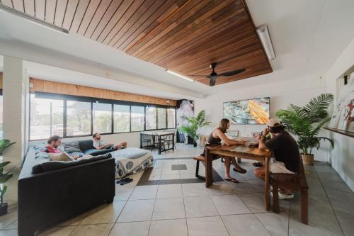a group of people sitting in a living room at Seaside Lodge Hostel Townsville- right next to coles, 2 mins walk to strand & CBD- Passport required in Townsville