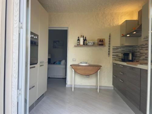 a kitchen with a wooden bowl on a table in it at Villa Marghe in Budoni
