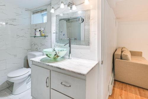 a bathroom with a sink and a toilet at 12 Mi to Dtwn Boston Apartment in Braintree in Braintree