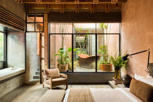 a room with a large window with plants in it at Casa Tenue in Mexico City