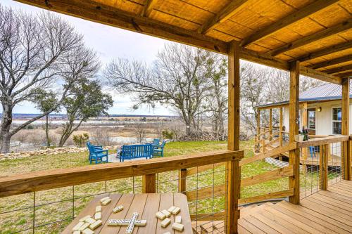 a wooden porch with a table and chairs on it at 9 Mi to Dtwn Granbury Getaway with Water Views in Weatherford