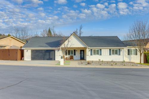 a white house with a driveway in front of it at Walk Downtown Remodeled Home in Murphys with Yard! in Murphys