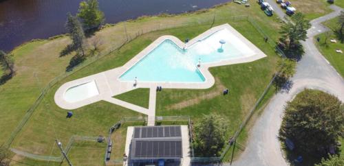 an overhead view of a swimming pool on top of a house at Peaceful Pocono Lakefront, beach, pools, firepit, pets in Arrowhead Lake