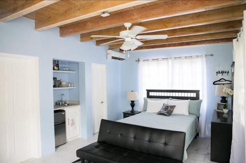 a bedroom with a bed and a ceiling fan at Tangerine Sunsets Alta Vista Studio One in Nassau