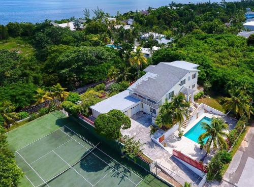 an aerial view of a house with a tennis court at Tangerine Sunsets Alta Vista Studio One in Nassau
